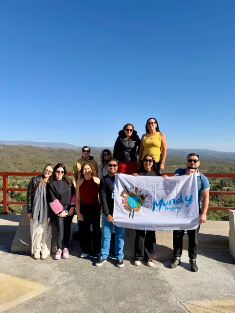 Grupo da Mundy com a bandeira no alto de um mirante argentino